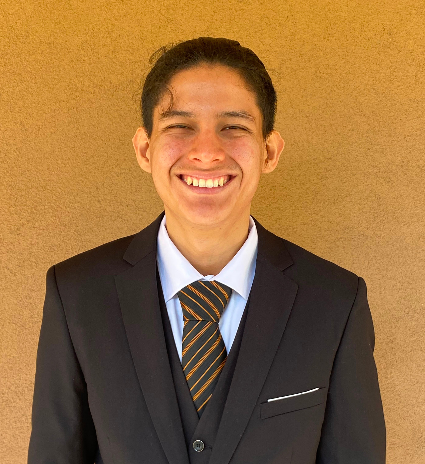 Diego Martinez in a suit, smiling